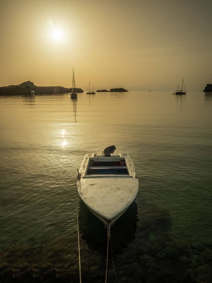 Photo of a boat moored near the main beach in Lindos. This is my favourite time of day to be on the beach, just me, the sun, the sea and the boats and all that lovely morning light