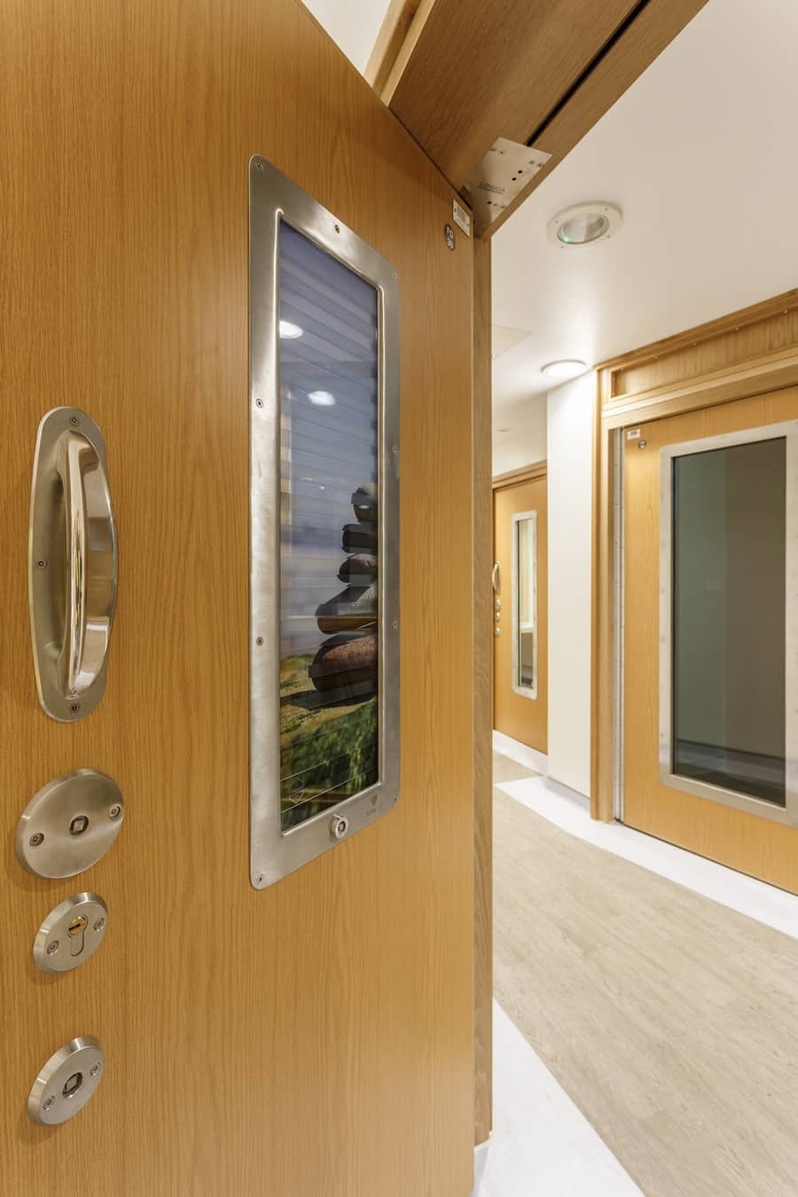  A close up picture of the ironmongery and blind on one of the doors - important details in a construction product shoot 