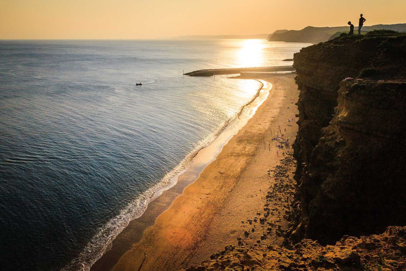  The view looking towards the sunset of the beach at West Bay. From the cliffs above 