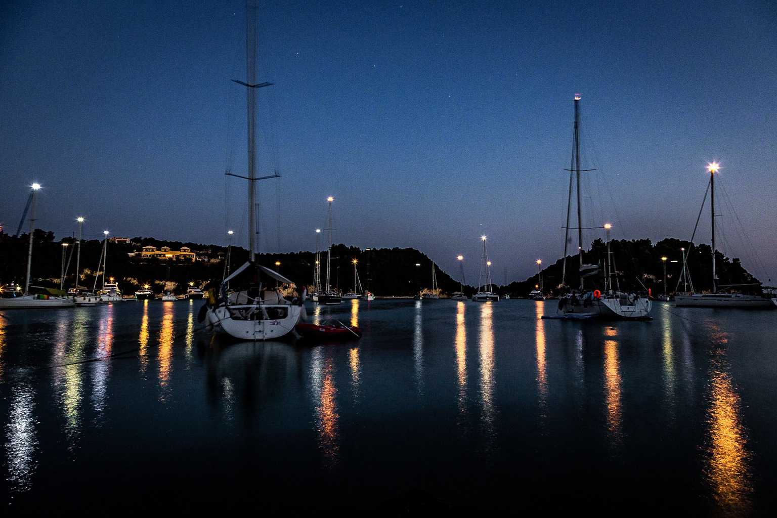  Boats in the night moored at Lakka on the Greek Island of Paxos 