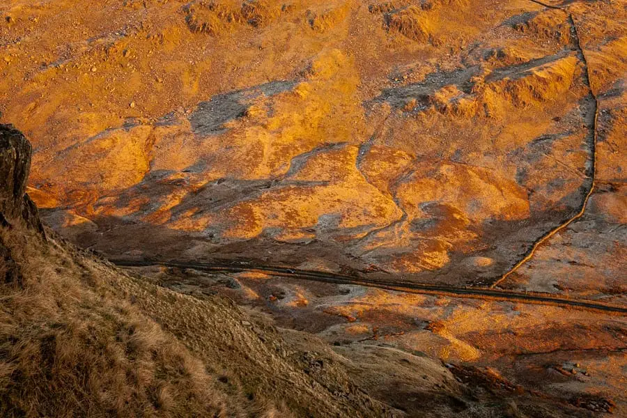 Kirkstone Pass viewed from the hills above as the sun sets.jpg