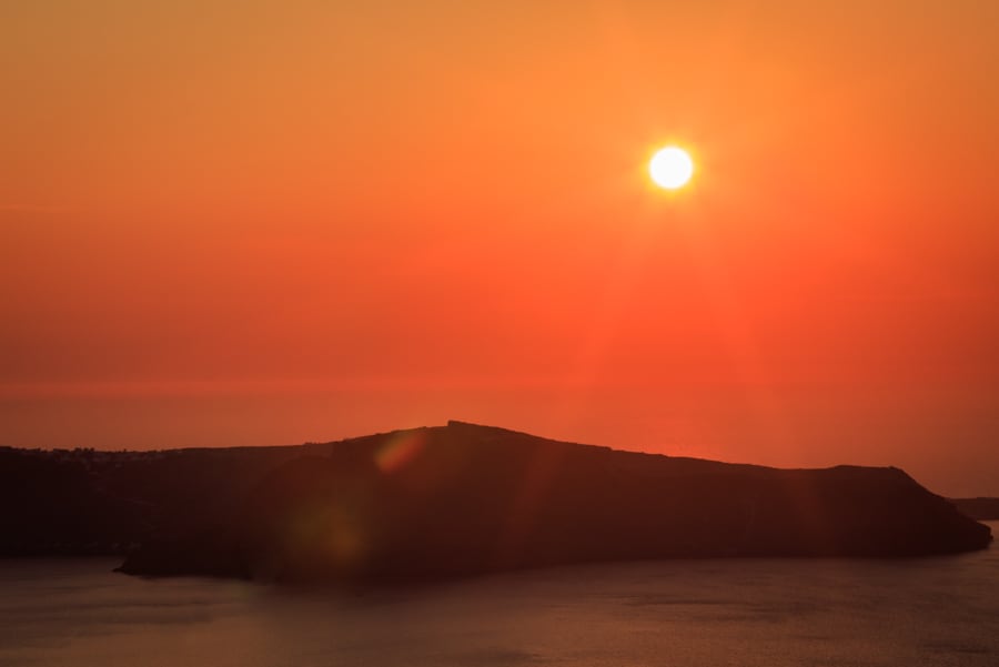 Golden sunshine over Thirasia viewed from mainlaind Santorini