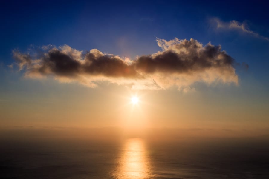 Sunrise picture of the sea, sun and clouds viewed from Santorini